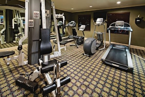 A gym with exercise equipment, a treadmill, and a patterned carpet. - Staybridge Suites Irving Las Colinas by IHG (Irving)