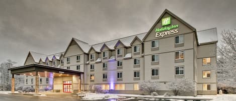 Edificio de Holiday Inn Express con entrada cubierta y varias ventanas.