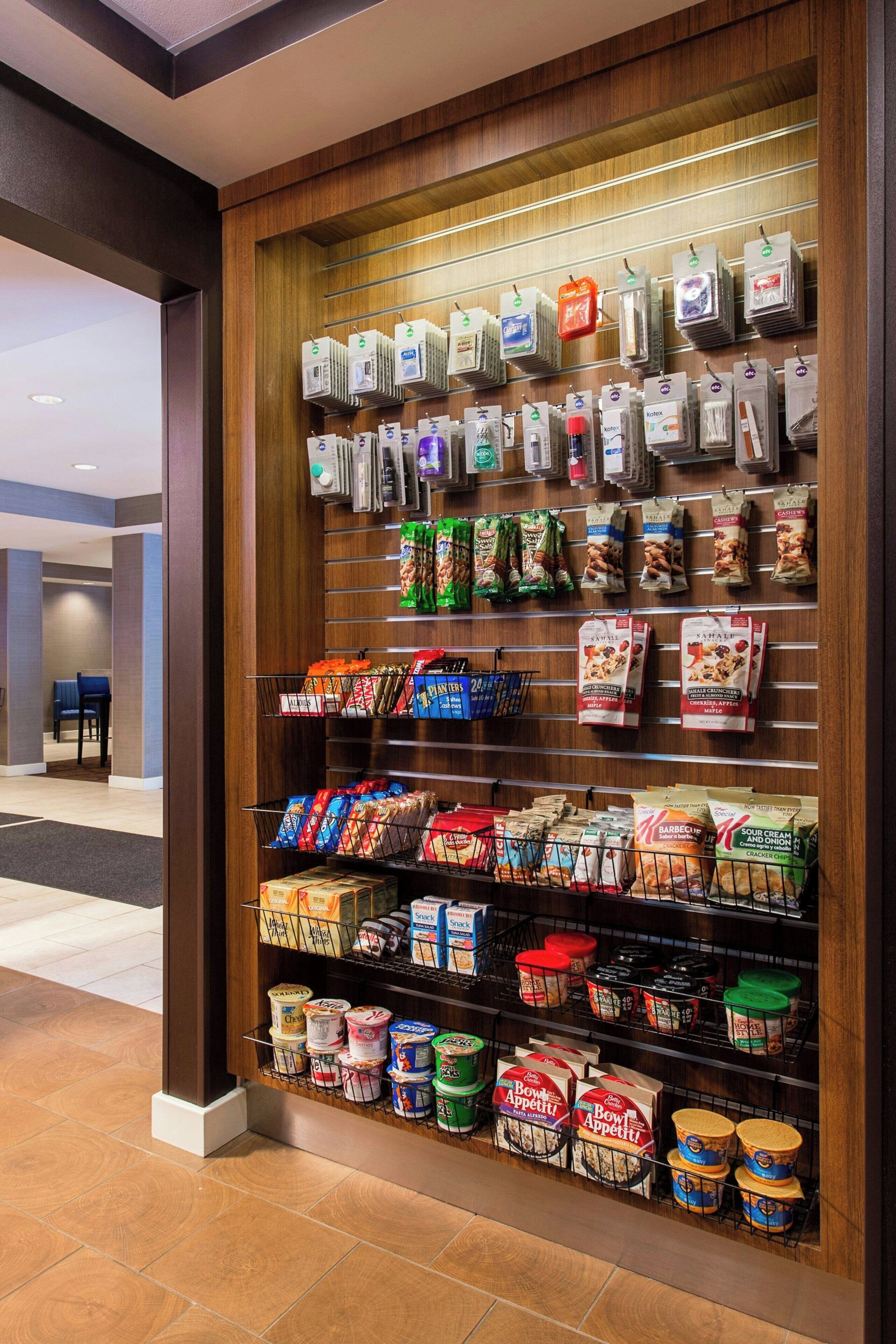 A grocery display with various packaged food items and beverages.