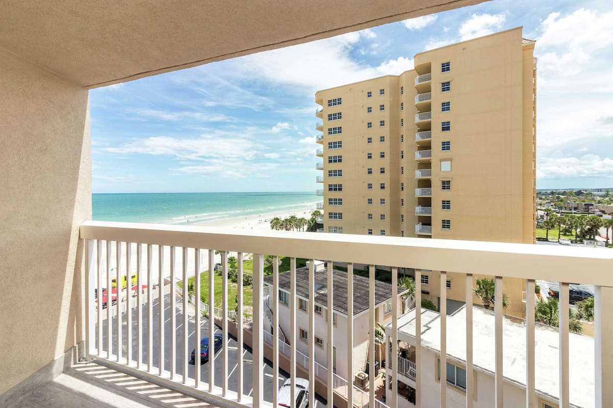 A high-rise building with a view of a beach and ocean.