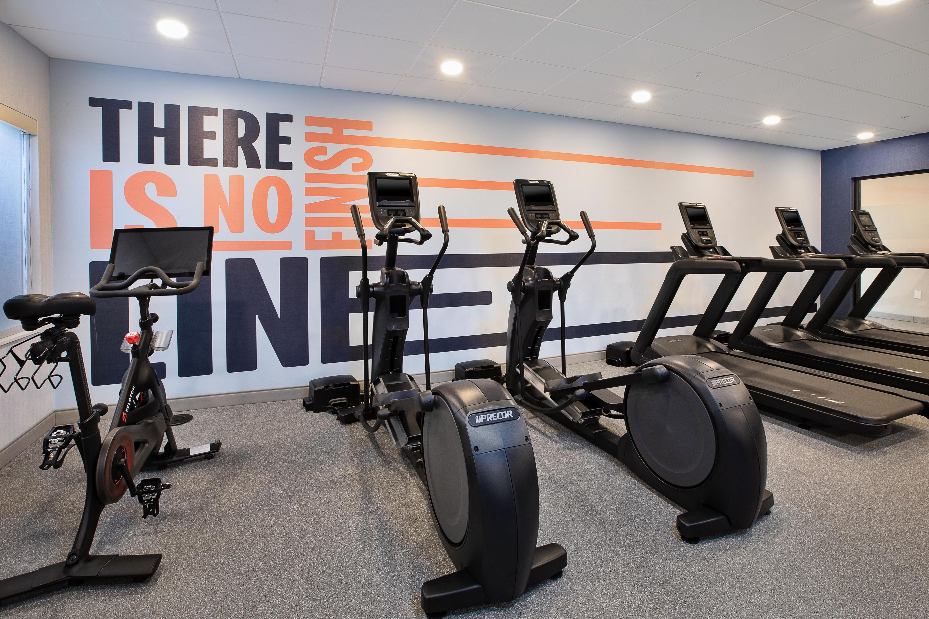 A gym with stationary bikes, elliptical machines, and treadmills.