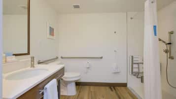 A modern bathroom with a sink, toilet, and shower.