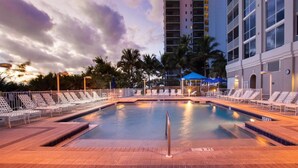 A hotel pool area with lounge chairs and a water feature. - GullWing Beach Resort (Fort Myers Beach)