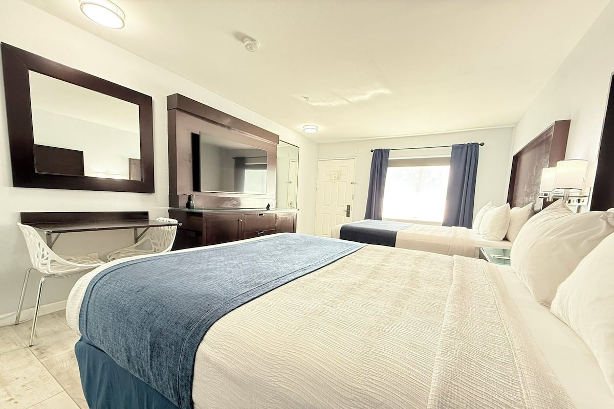 Deluxe Room, 2 Queen Beds, Non Smoking | Desk, laptop workspace, blackout drapes, iron/ironing board