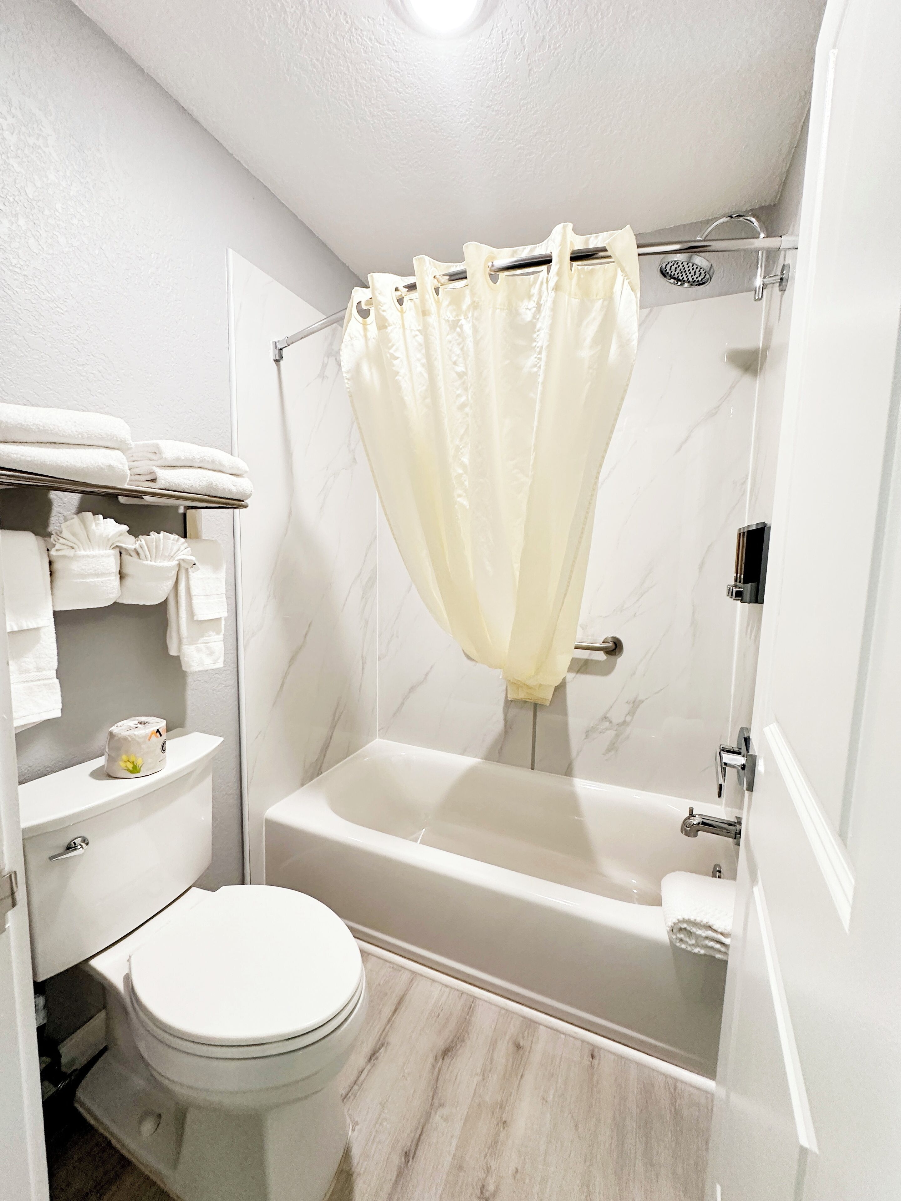 deluxe room, 2 queen beds, non smoking, refrigerator & microwave | bathroom | combined shower/bathtub, hair dryer, towels