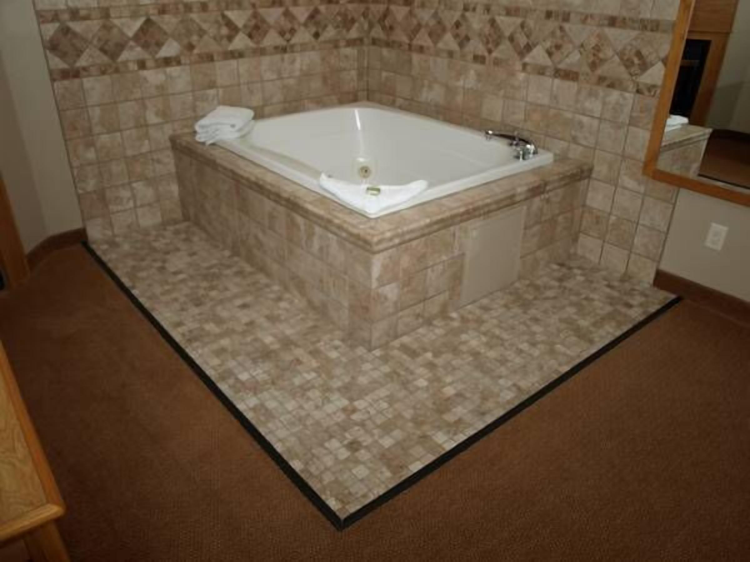 premium suite, 1 king bed with sofa bed, hot tub | jetted bathtub