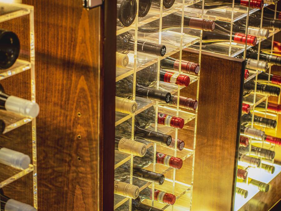 A wine rack with multiple bottles.