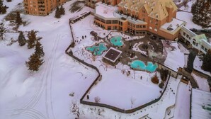 A large resort with multiple buildings, a swimming pool, and a snow-covered landscape. - Chateau Cartier Hotel & Resort, an Ascend Collection Resort (Gatineau)