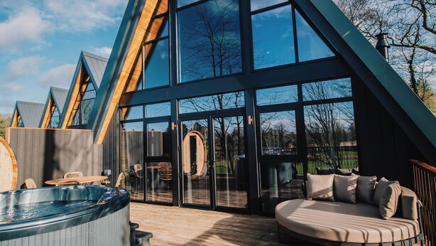 A modern house with a large glass facade, a wooden deck, and a hot tub. - Ramside Hall Hotel, Golf and Spa (Durham)