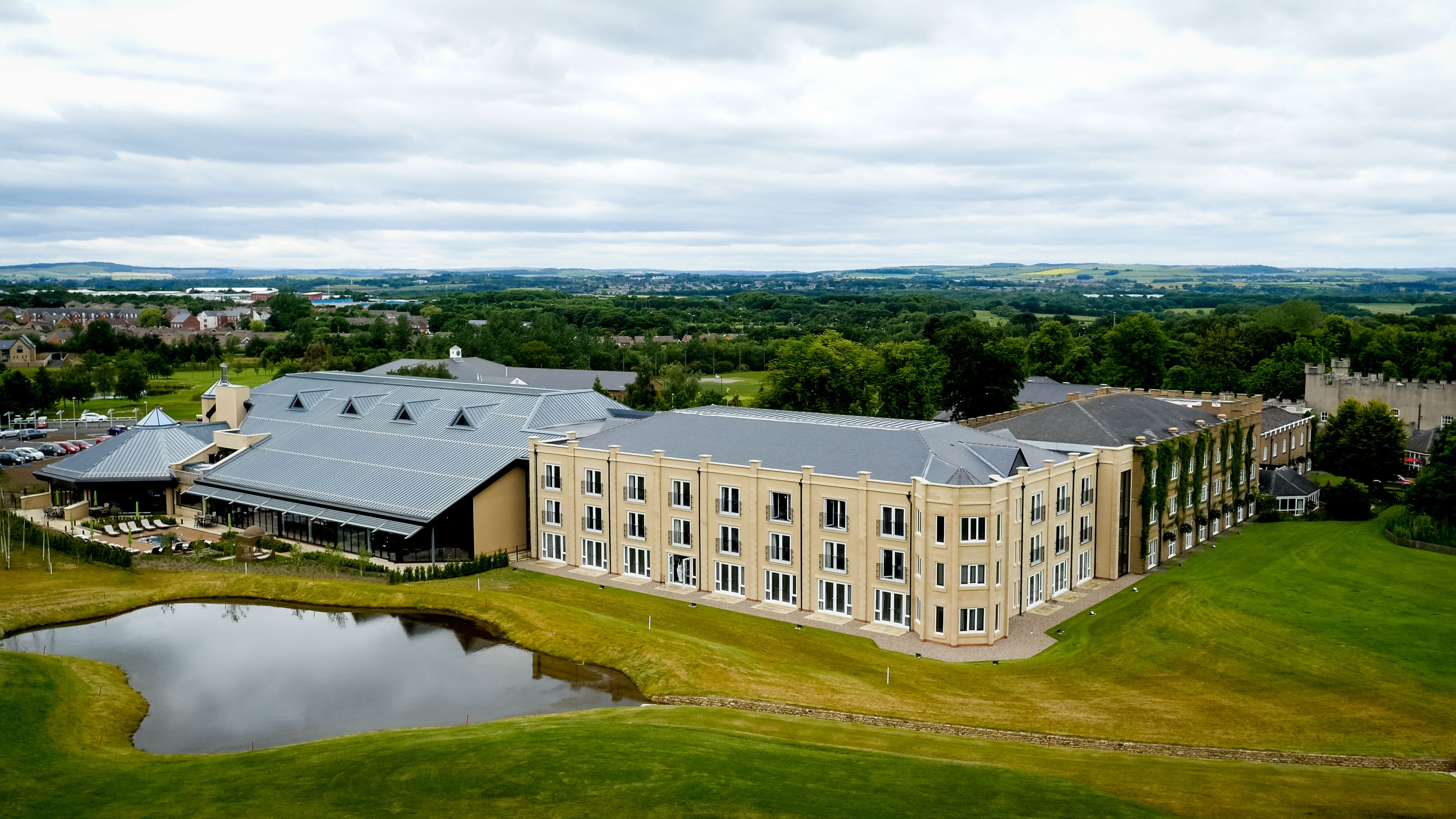 A large building with multiple windows and a courtyard.