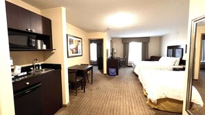 A hotel room with a kitchenette, a bed, a desk, and a large mirror. - Ramada by Wyndham Prince Albert (Prince Albert)
