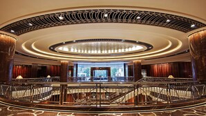A grand lobby with a central staircase, ornate ceiling, and a view of the outdoors. - Park Hyatt Melbourne (East Melbourne)