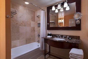 Combined shower/tub, designer toiletries, hair dryer, towels at The Stephen F Austin Royal Sonesta Hotel