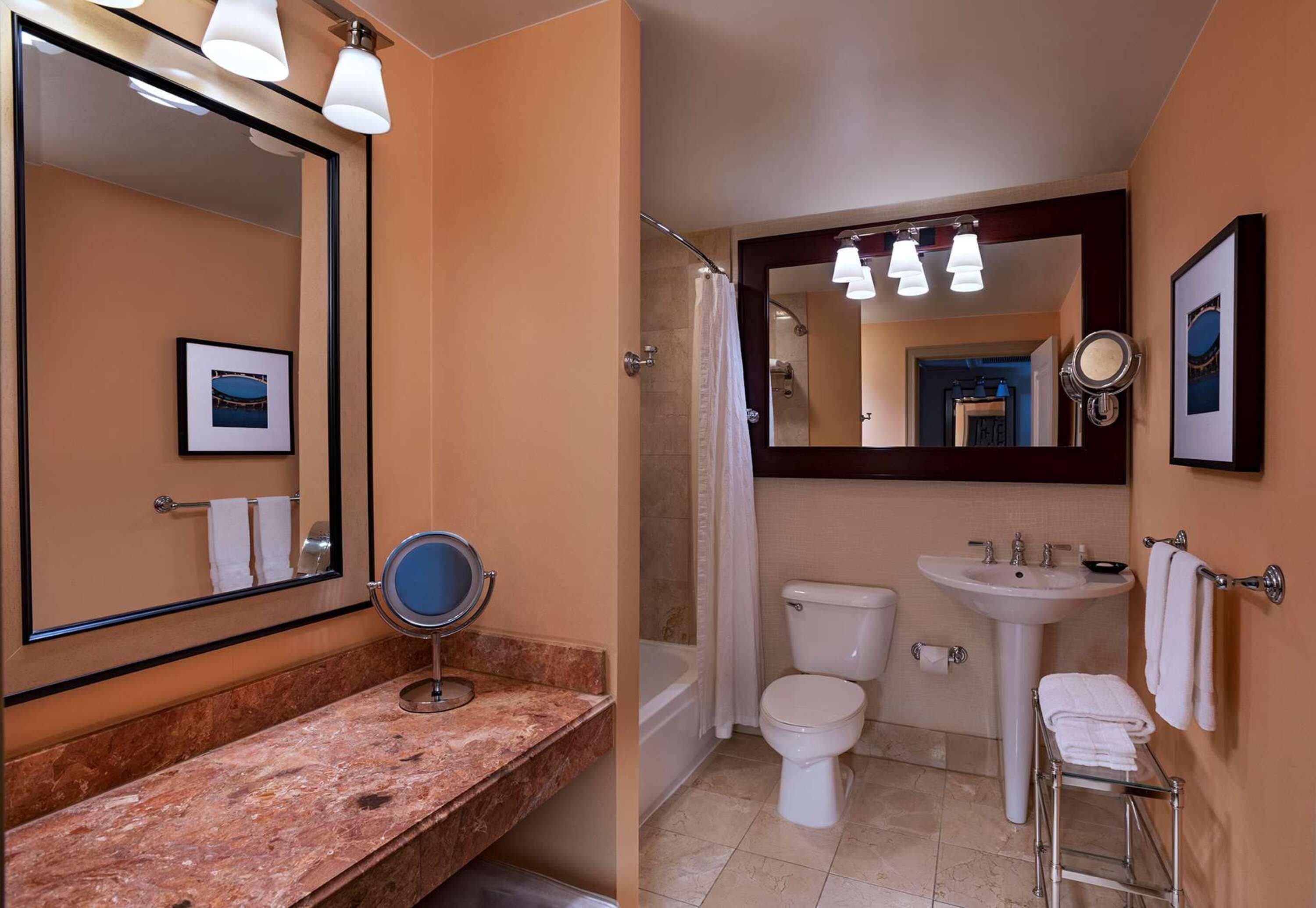 combined shower/bathtub, designer toiletries, hair dryer, towels