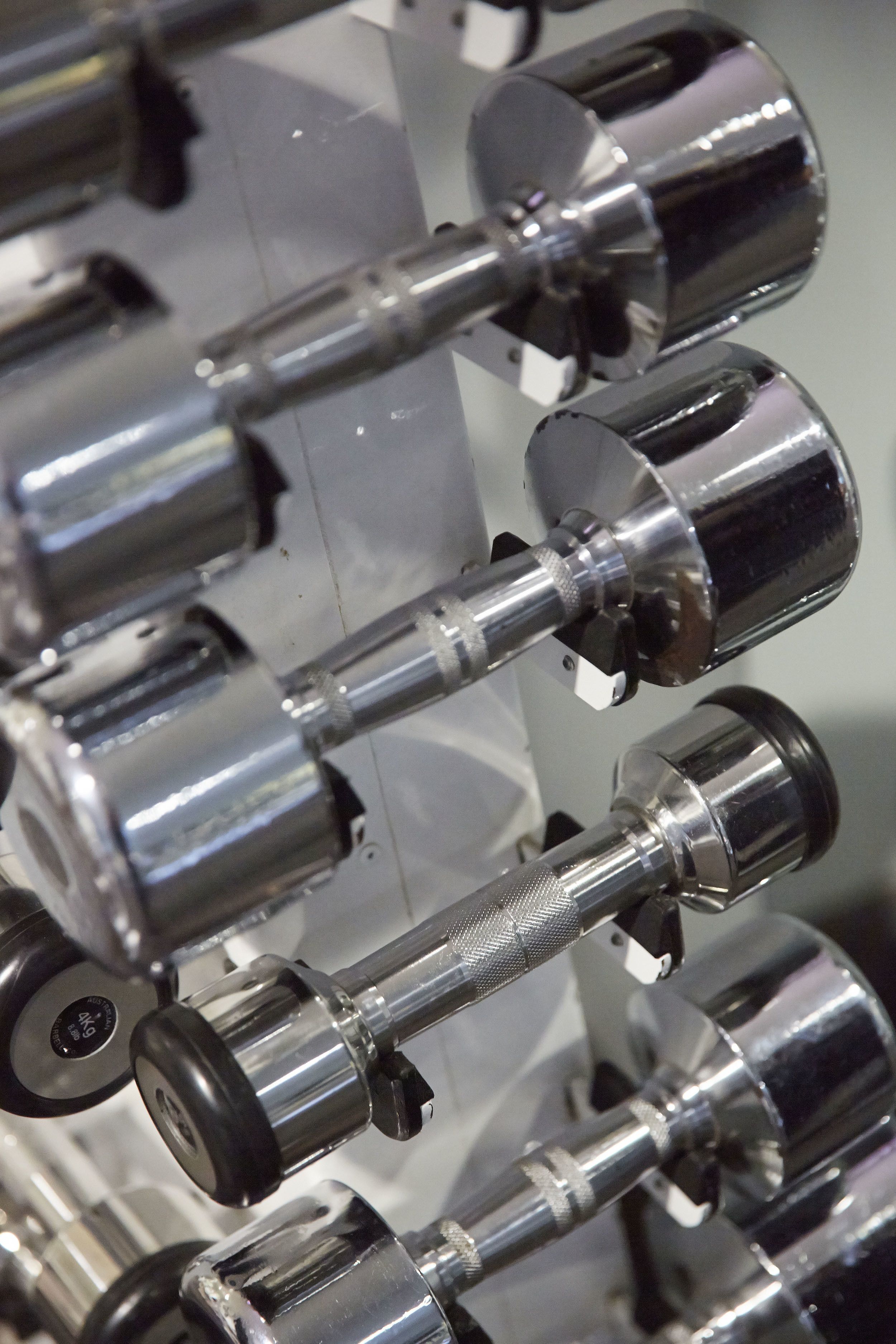 A close-up of a metallic, cylindrical object with a textured grip, likely part of a mechanical or industrial device.