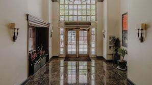 A hotel lobby with a marble floor, a large arched window, and a double door entrance. - Club Quarters Hotel Rittenhouse Square, Philadelphia (Philadelphia)