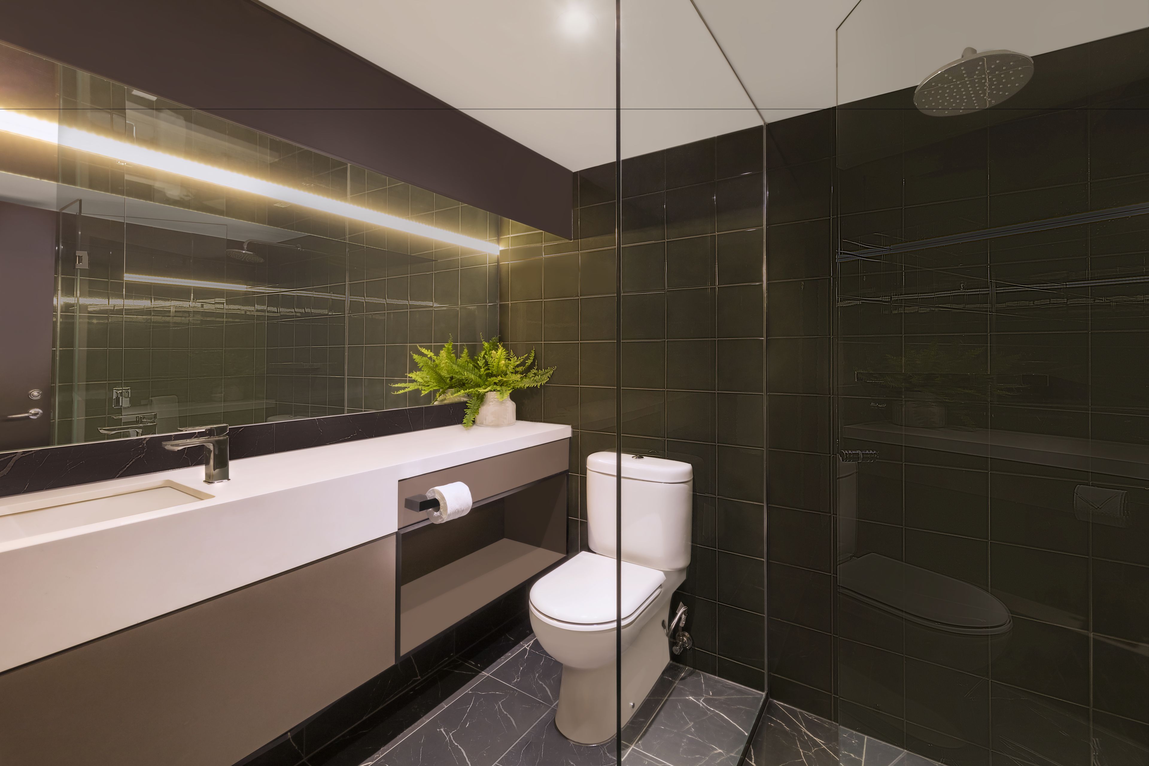 A modern bathroom with a glass shower enclosure, a white toilet, and a marble-tiled floor.