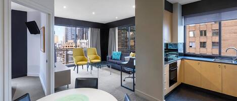 A modern apartment with a dining area, kitchen, and a balcony with city views.