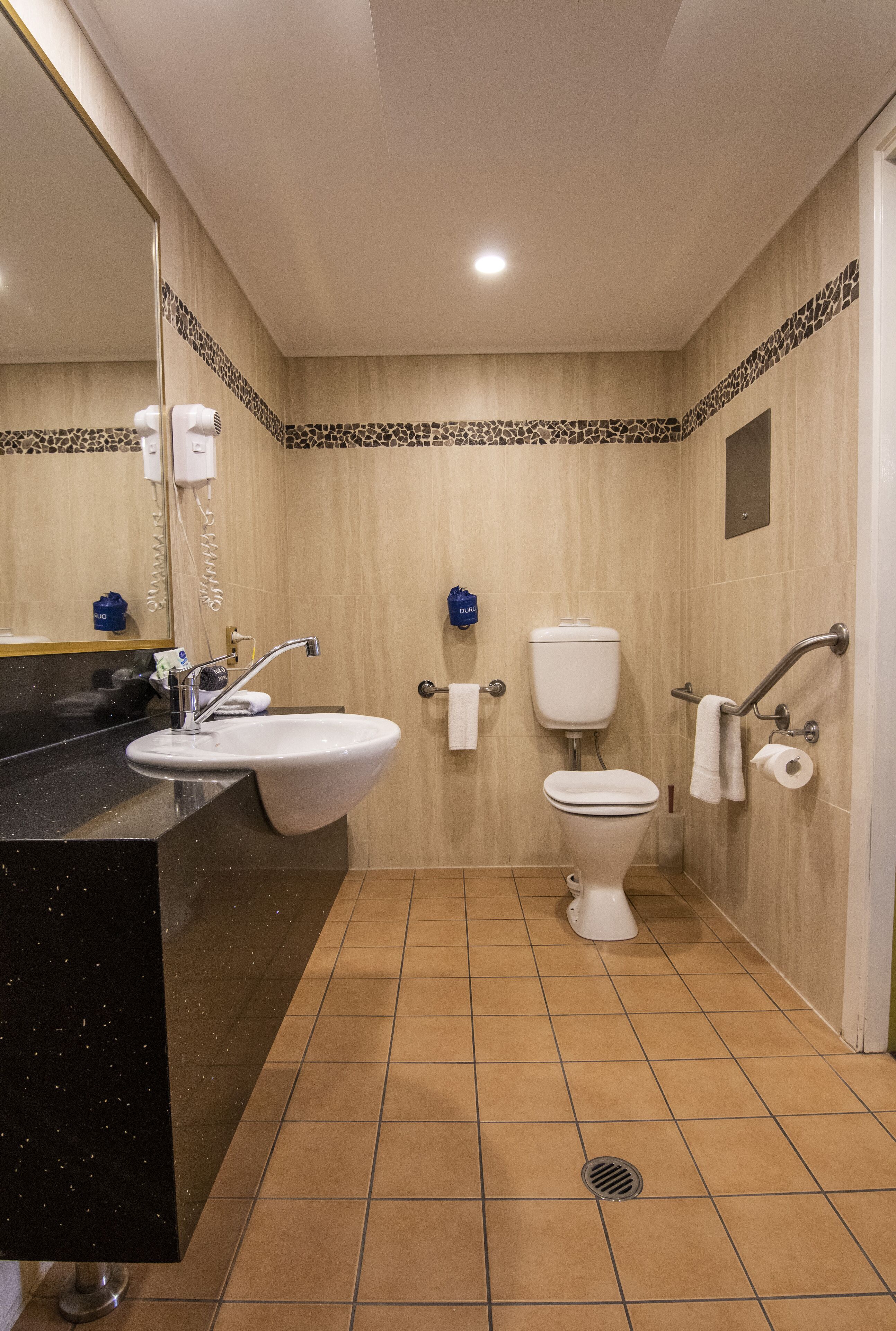 designer toiletries, hair dryer, towels