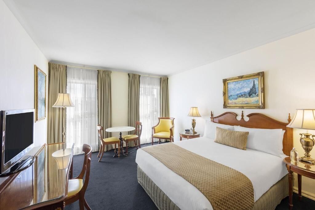 Standard Room | Desk, laptop workspace, blackout drapes, iron/ironing board