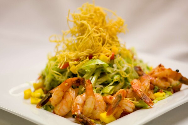 A plate of shrimp and noodles with vegetables. - Hilton Vancouver Airport (Richmond)