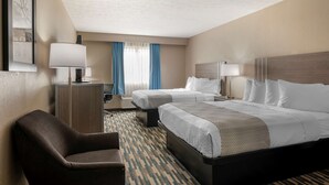 A hotel room with two beds, a desk, a chair, and a large window with blue curtains. - Best Western Edinburgh/Columbus (Edinburgh)