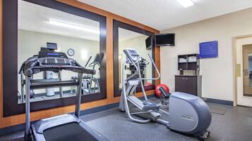 A gym with a treadmill, elliptical, and a stationary bike.