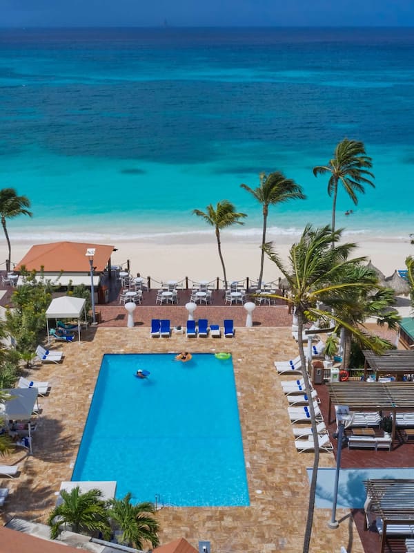 On the beach, white sand, sun loungers, beach towels