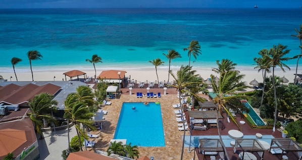 On the beach, white sand, sun-loungers, beach towels