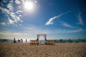 On the beach, white sand, sun loungers, beach umbrellas