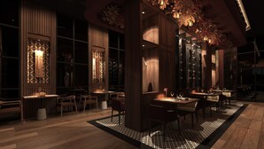 A dimly lit restaurant with wooden furniture and patterned decor. - Hotel Riu Palace Aruba - All Inclusive (Noord)