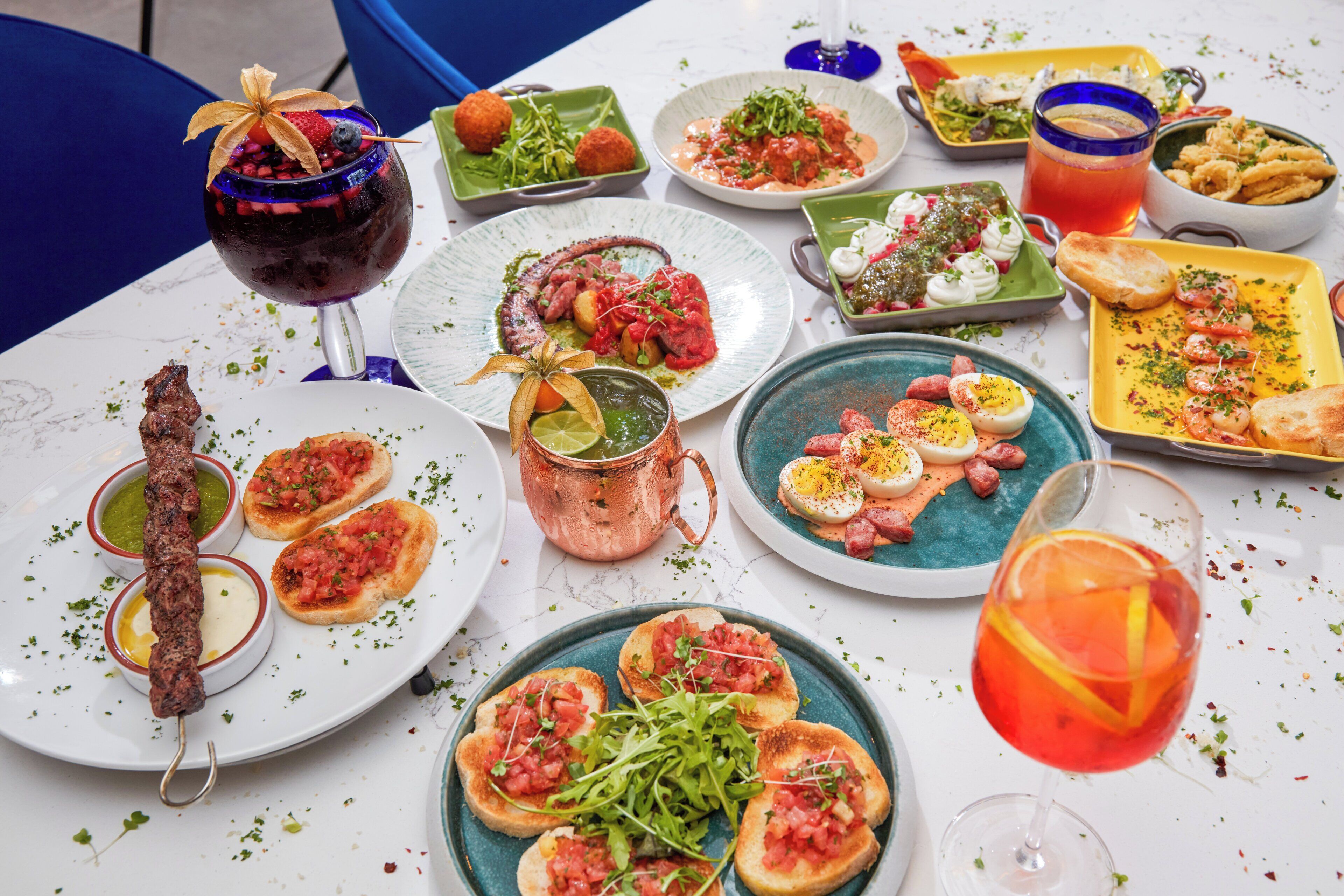 Una mesa con diversos platos y bebidas, indicando un ambiente de comedor.