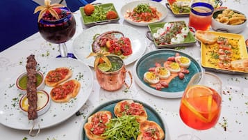 A table with various dishes and drinks, suggesting a dining setting.