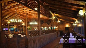 Un interior de madera con techos altos y una larga zona de comedor.