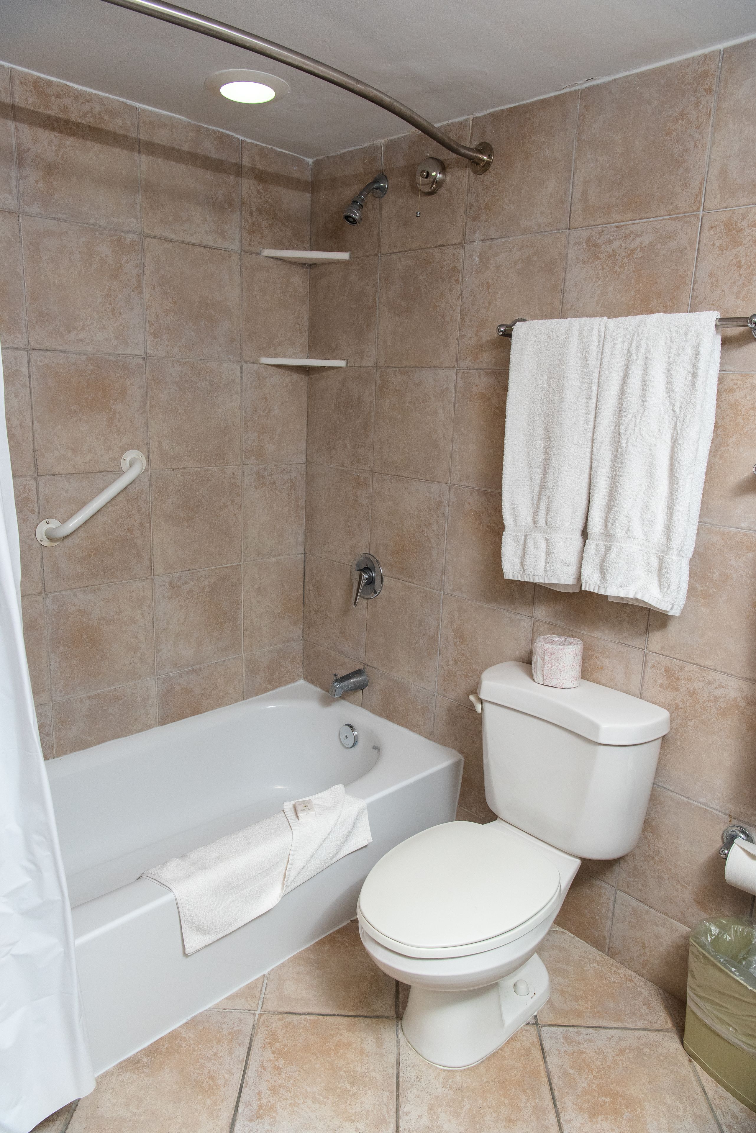 A bathroom with a bathtub, toilet, and shower.