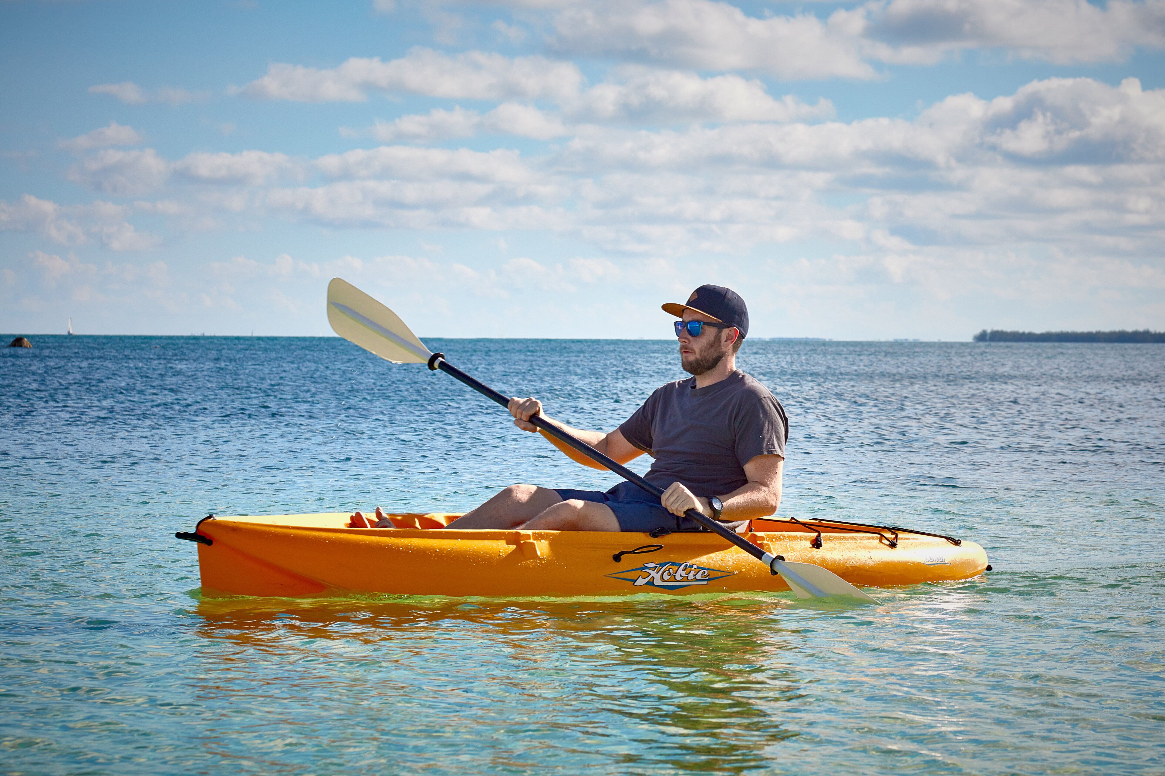 A man in a kayak on a body of water.