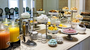 A buffet with various food items, including eggs, fruits, pastries, and beverages. - Chateau Versailles (Montreal)