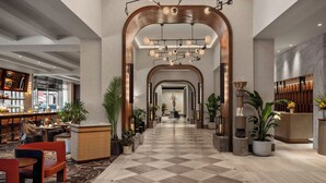 A spacious lobby with a checkered floor, a reception desk, and a bar area. - Sofitel Philadelphia at Rittenhouse Square (Philadelphia)