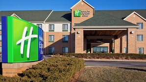 A Holiday Inn Express & Suites with a prominent green and blue sign, brick facade, and a covered entrance. - Holiday Inn Express Hotel & Suites Pleasant Prairie-Kenosha by IHG (Pleasant Prairie)