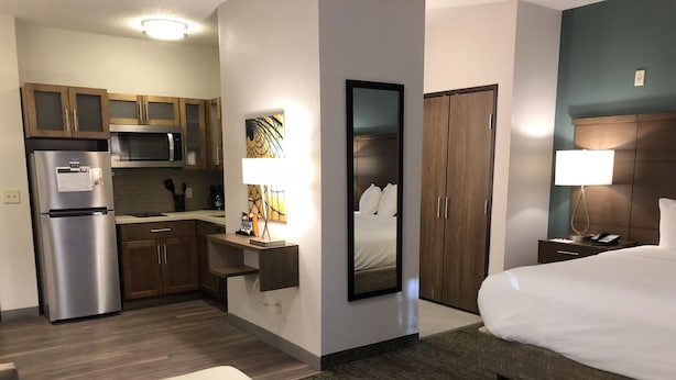 A hotel room with a bed, a desk, a kitchenette, and a bathroom. - Staybridge Suites Columbia by IHG (Columbia)