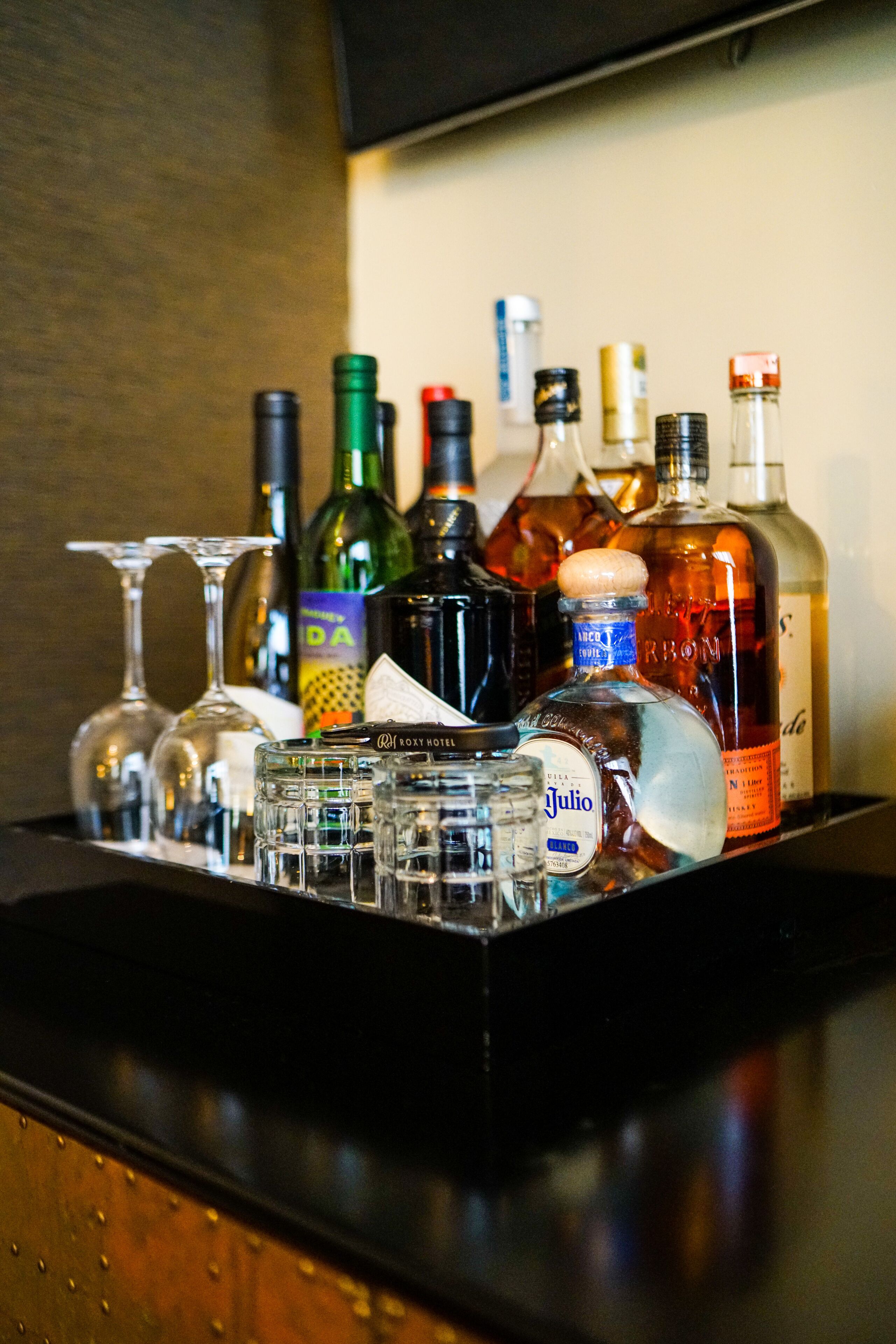 A bar area with various bottles and glasses.