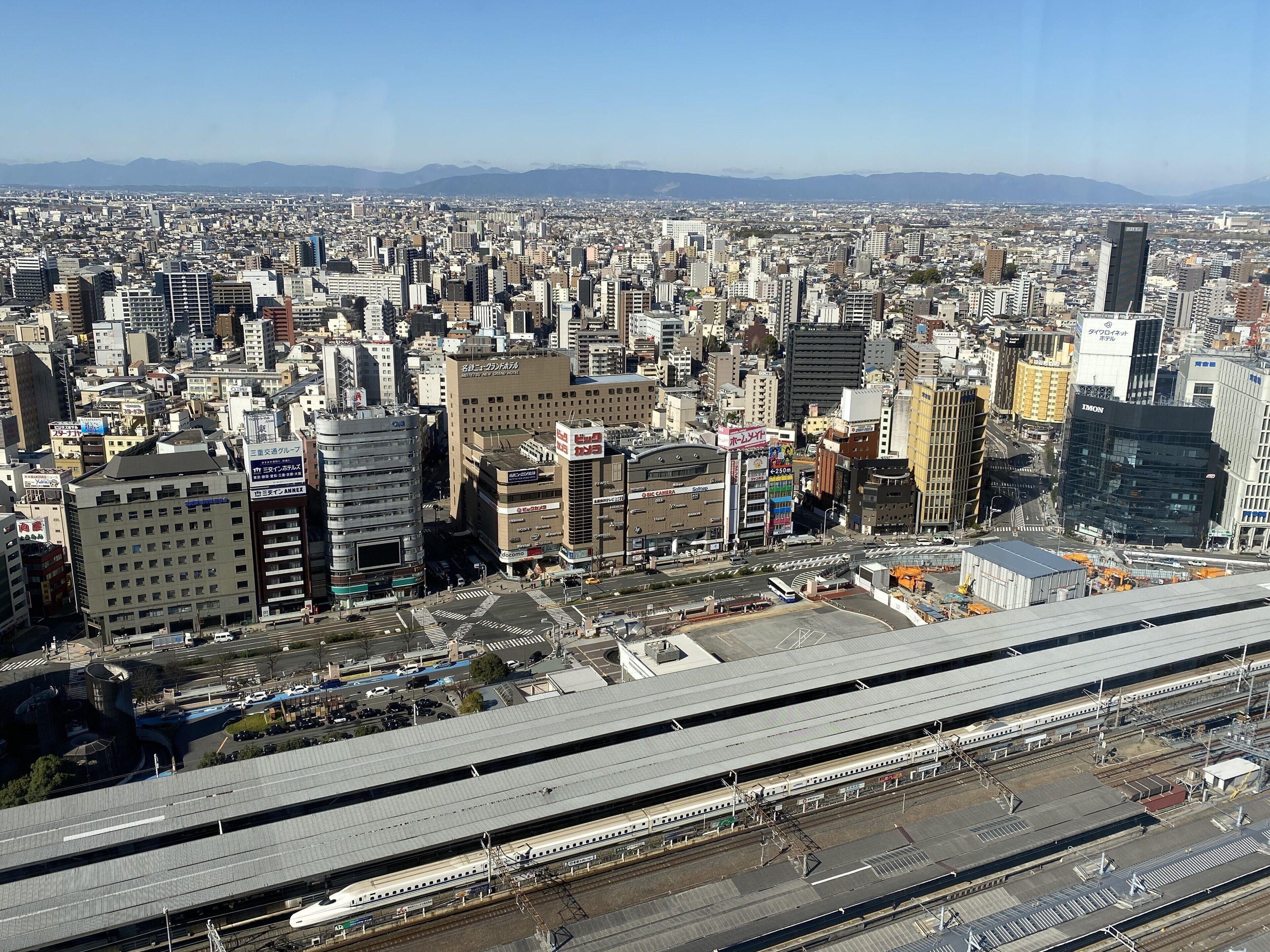 A cityscape with a prominent train station and surrounding buildings.