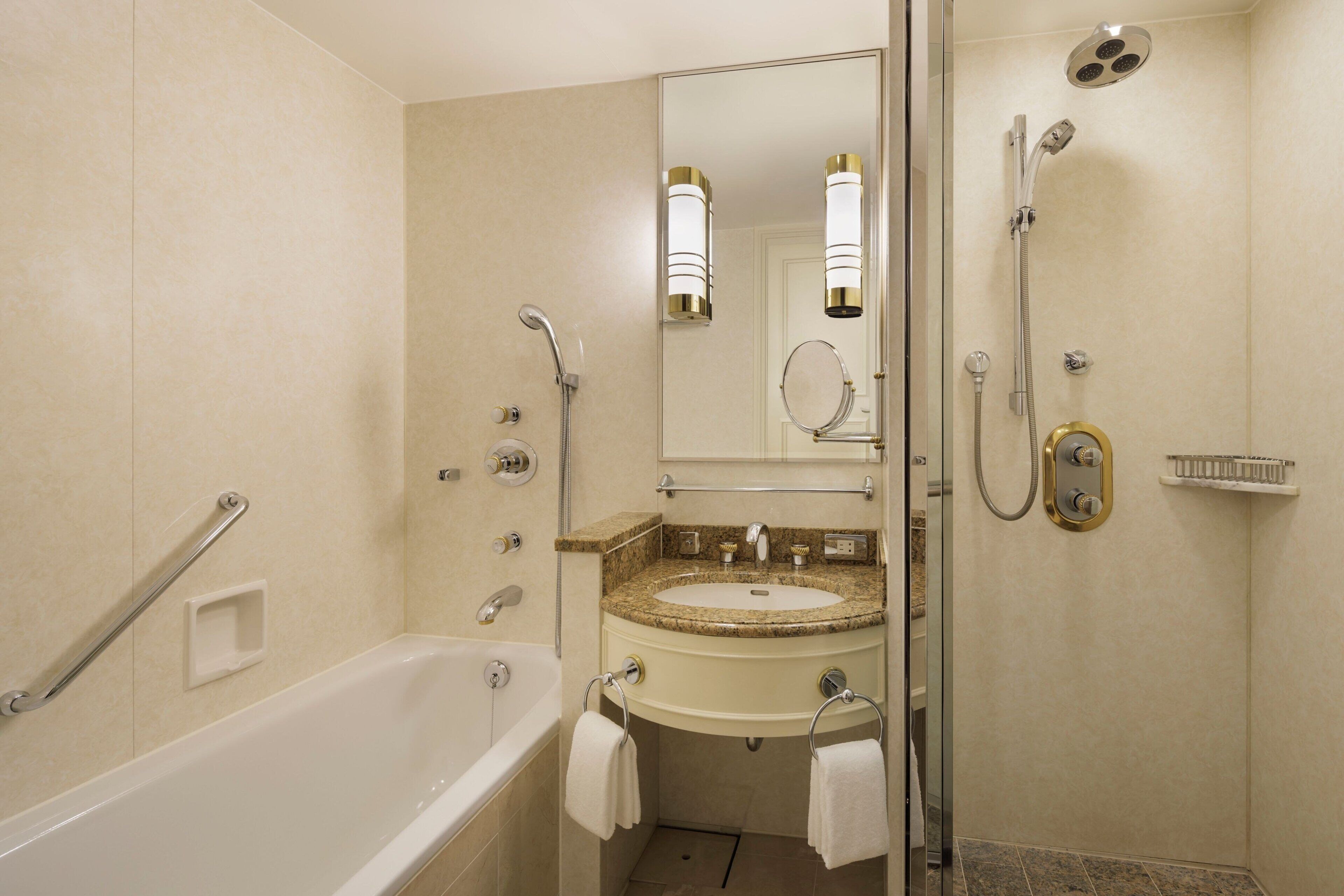 A modern bathroom with a bathtub, a sink, and a shower.