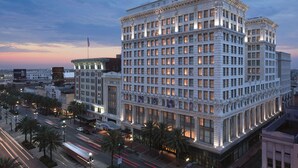 A large, multi-story building with a classical architectural style, featuring numerous windows and a prominent entrance.