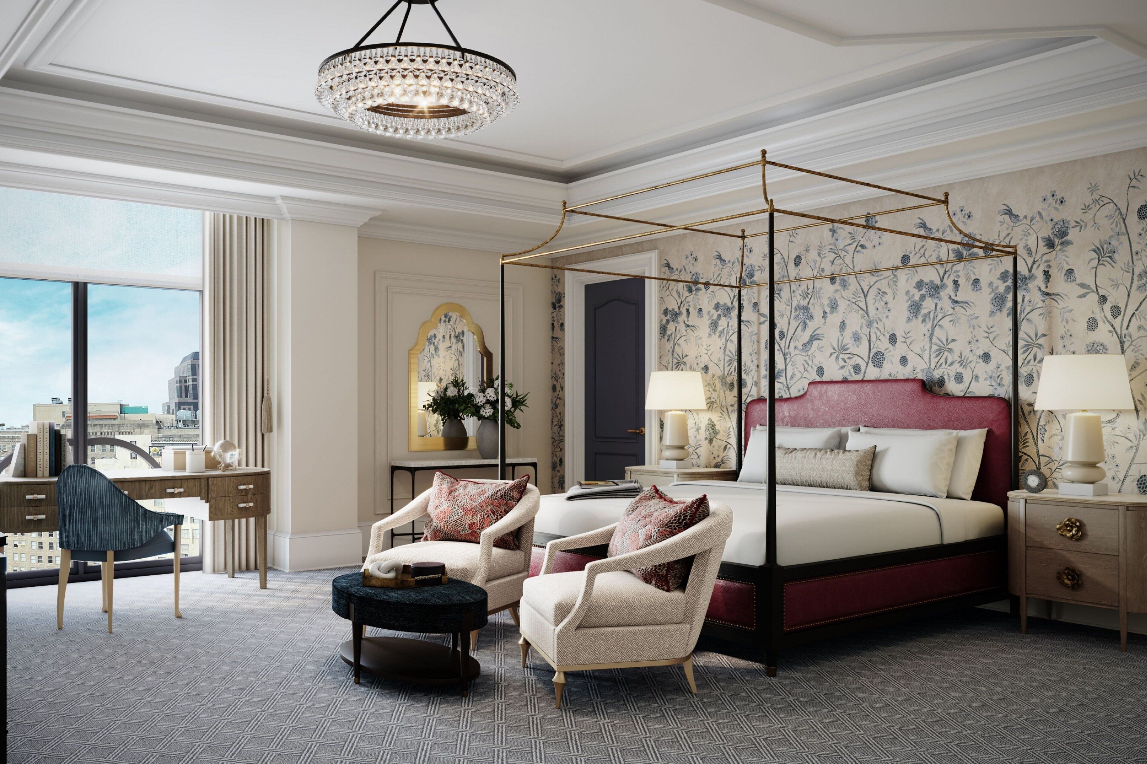 A spacious bedroom with a four-poster bed, a desk with a chair, and a view of the city.