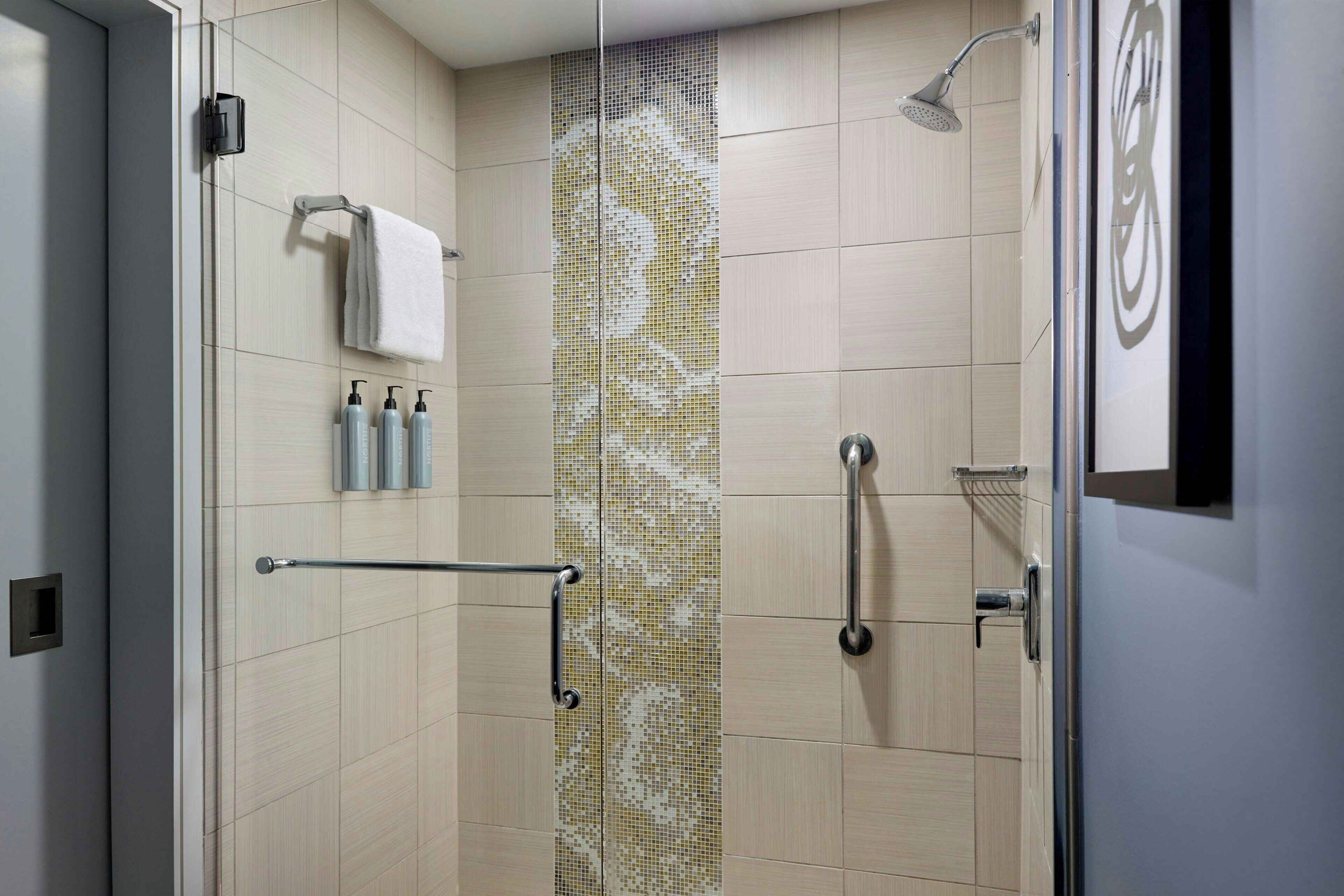 combined shower/bathtub, designer toiletries, hair dryer, towels