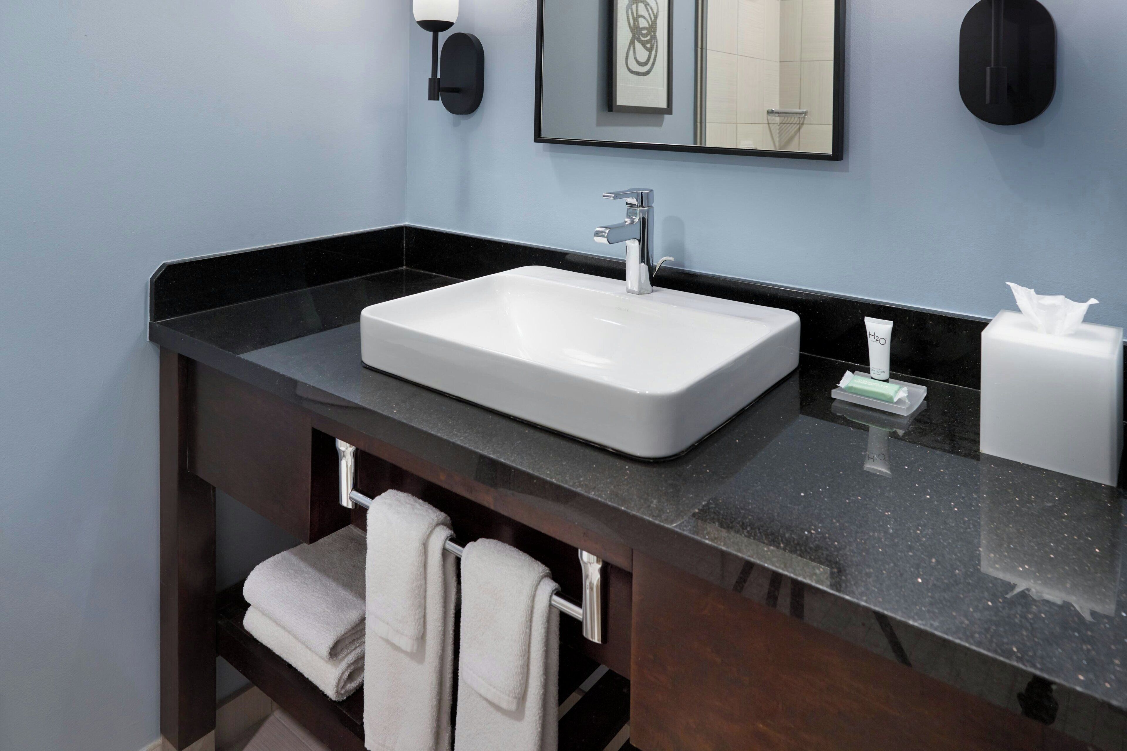 combined shower/bathtub, designer toiletries, hair dryer, towels