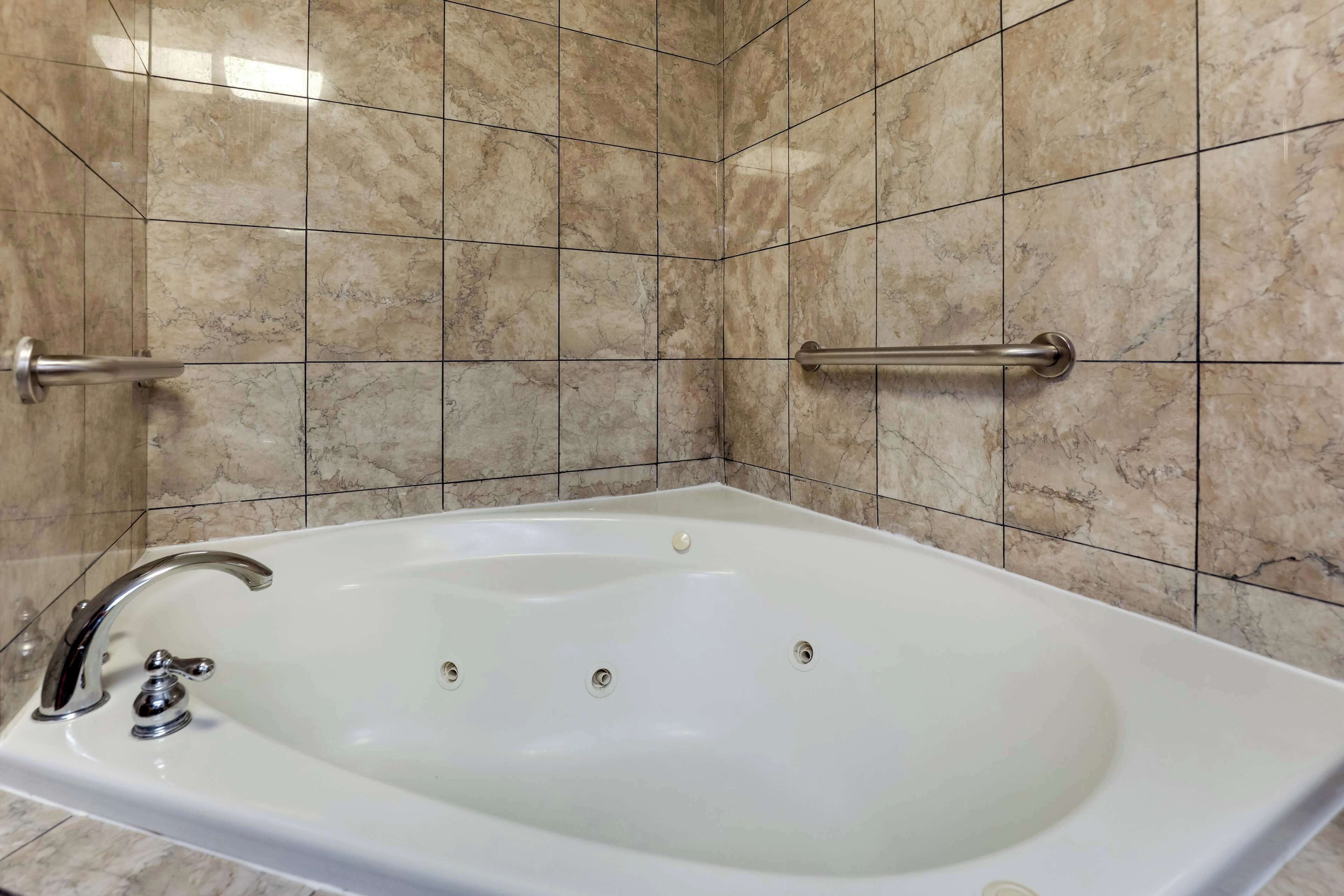 suite, 1 king bed with sofa bed, refrigerator & microwave (2 rooms, jetted tub) | bathroom | combined shower/bathtub, free toiletries, hair dryer, towels