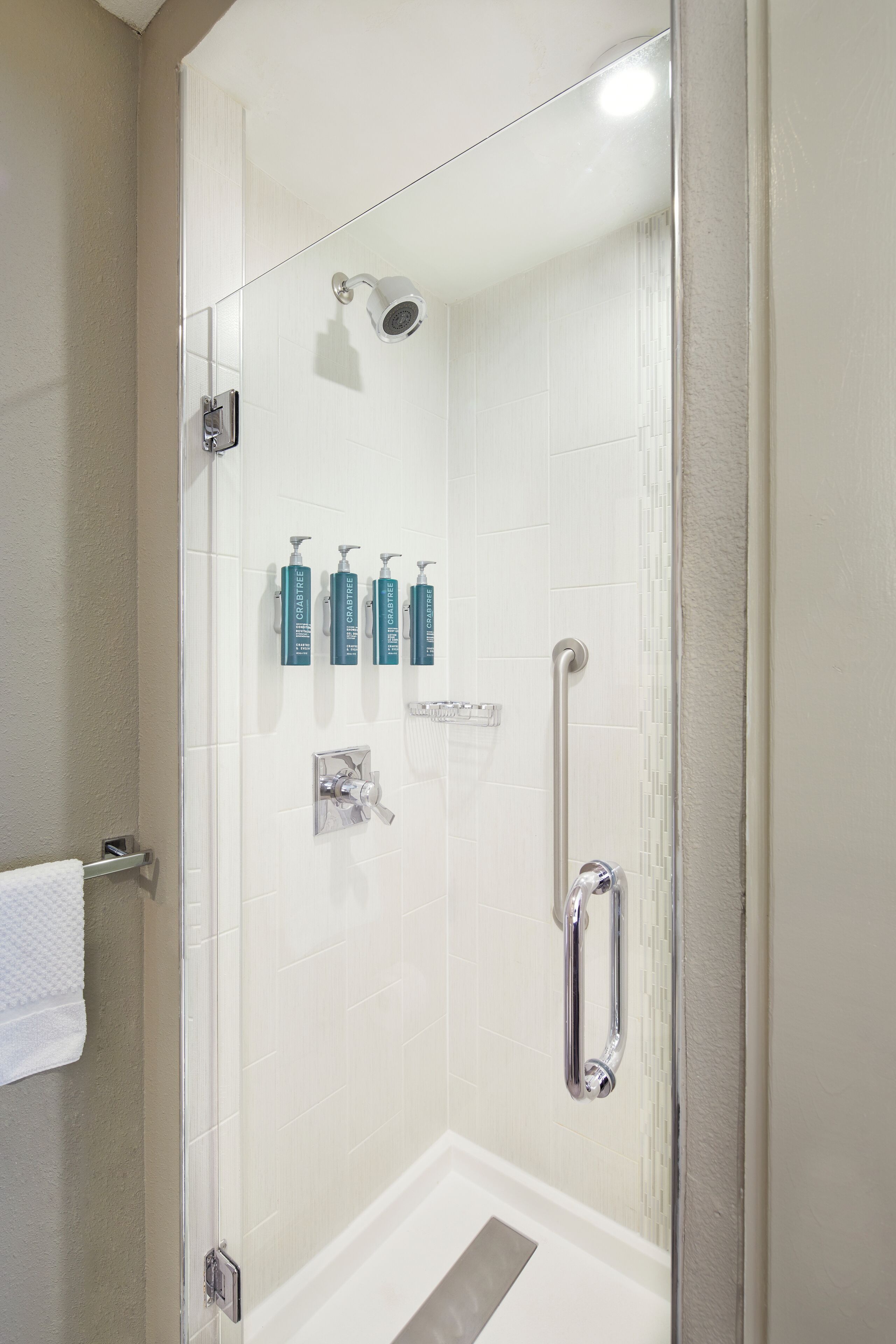 shower, designer toiletries, hair dryer, towels