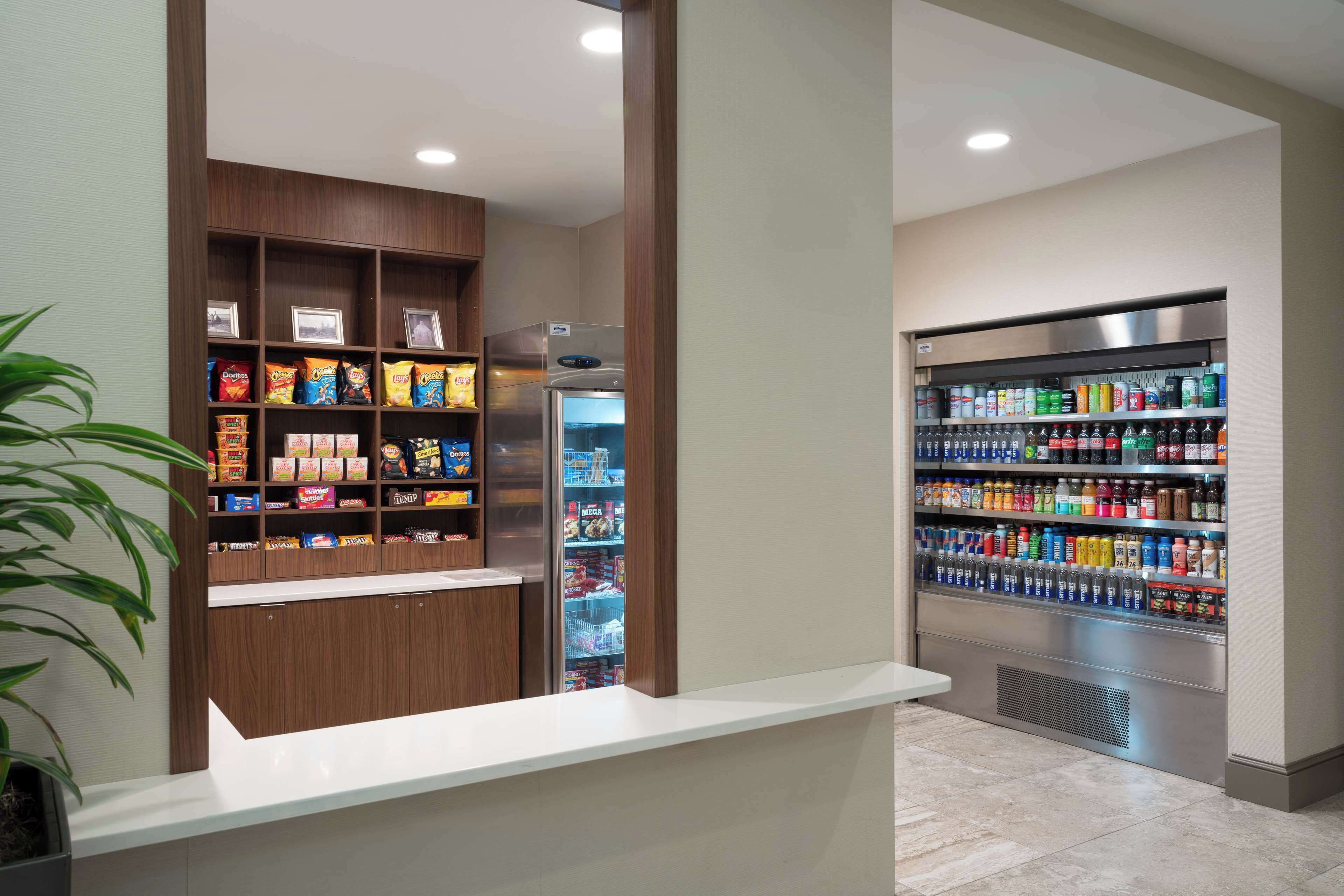 A snack and beverage kiosk with shelves stocked with snacks and drinks.